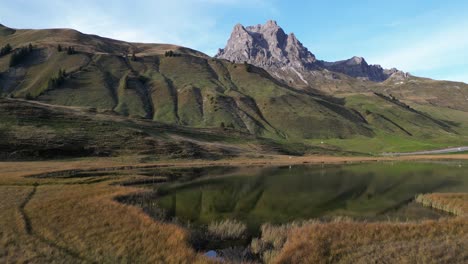 Zoom-in-shot-of-a-little-lake-situated-in-the-valley-between-the-mountain-summit