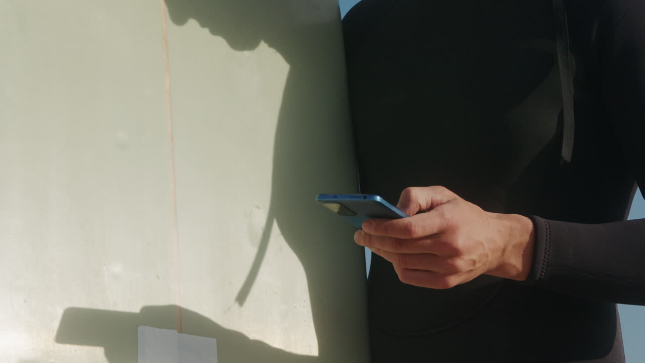 Surfer man walking to the beach at sunset preparing for surfing training and search for waves in Barcelona, spain, water, ocean exercise in sea with board, athletic male holiday or travel in vacation