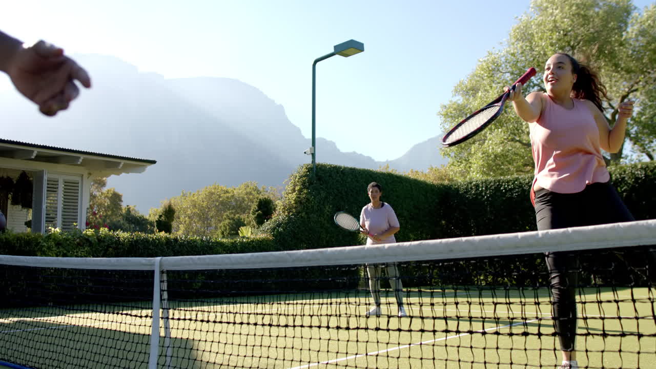 Playing tennis outdoors, Diverse Friends enjoying match on sunny day, having fun