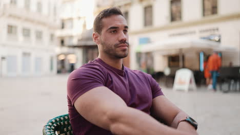 young man sitting in cafe and checking phone.