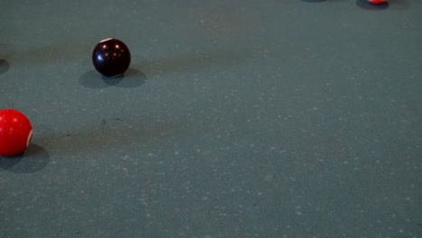 a slow motion shot of the cue ball making the breaking shot in pool