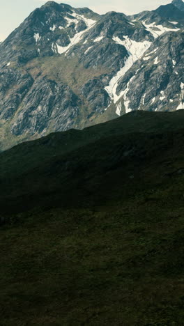 snow-capped mountain peaks in a green valley