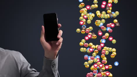 Hand-Hält-Smartphone-Mit-Spawnenden-Emoticons