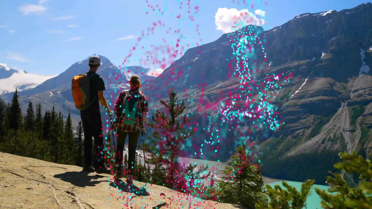 Couple holding hands while standing on mountain overlook, with animated health data graph overlay