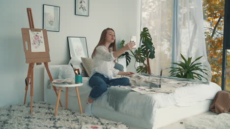 mujer joven artista haciendo transmisión en vivo con un teléfono inteligente