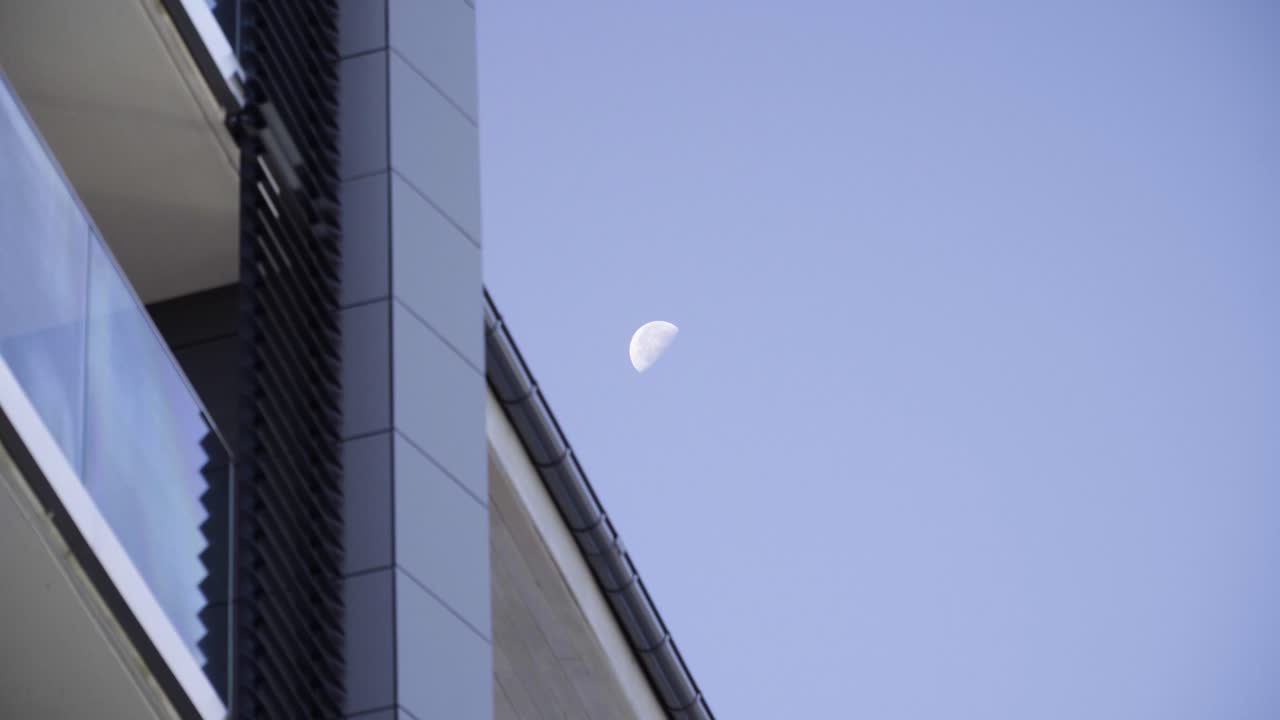 Half Moon over Modern Building