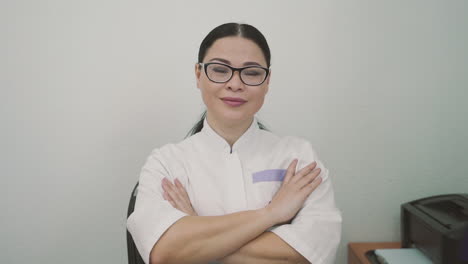 Female-Doctor-With-Glasses-Looks-Directly-Into-The-Camera