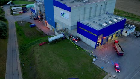 aerial view of fire brigade operation at waste incineration plant - drone shot