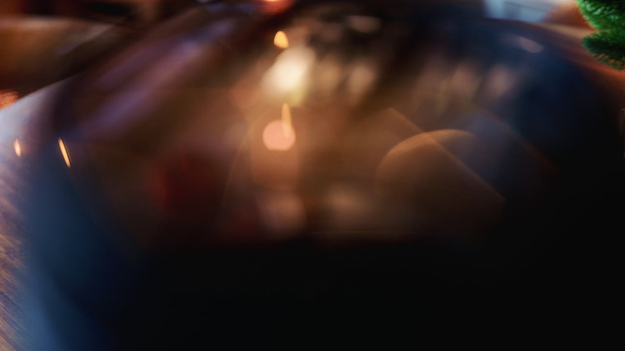 Close up of a camera lens showing curved glass elements and internal reflections