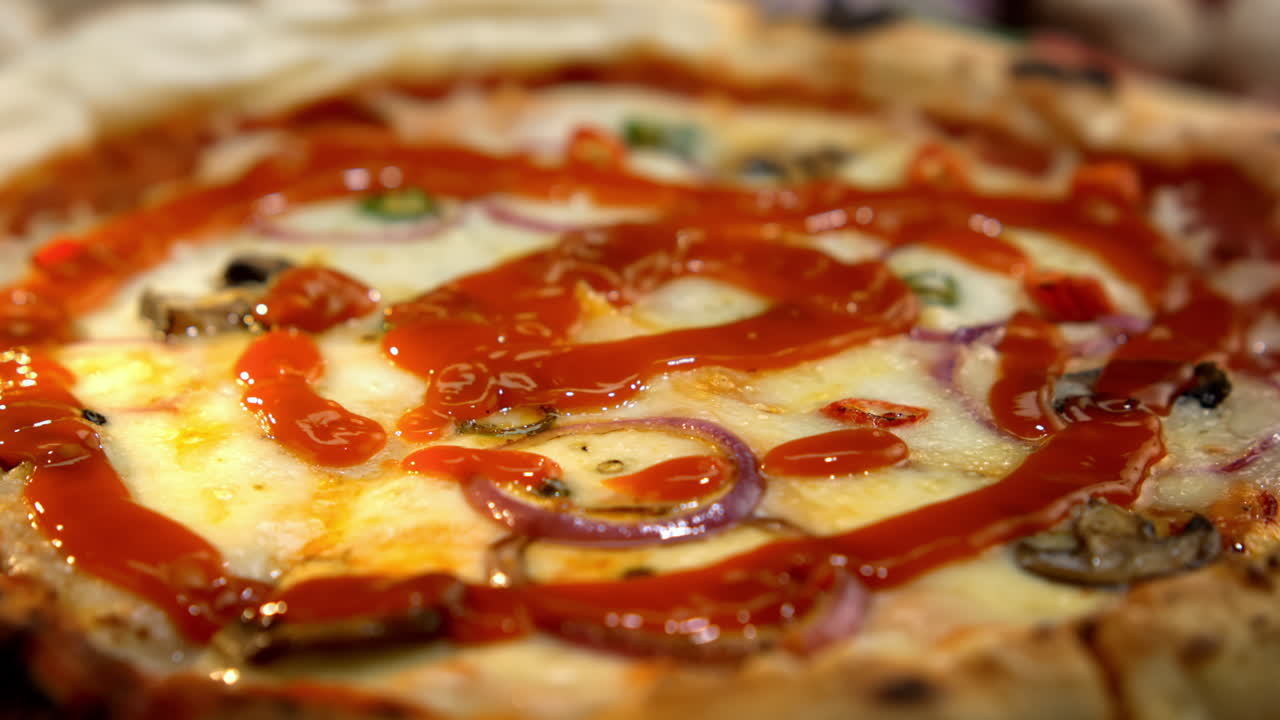 Pizza with ketchup and various toppings