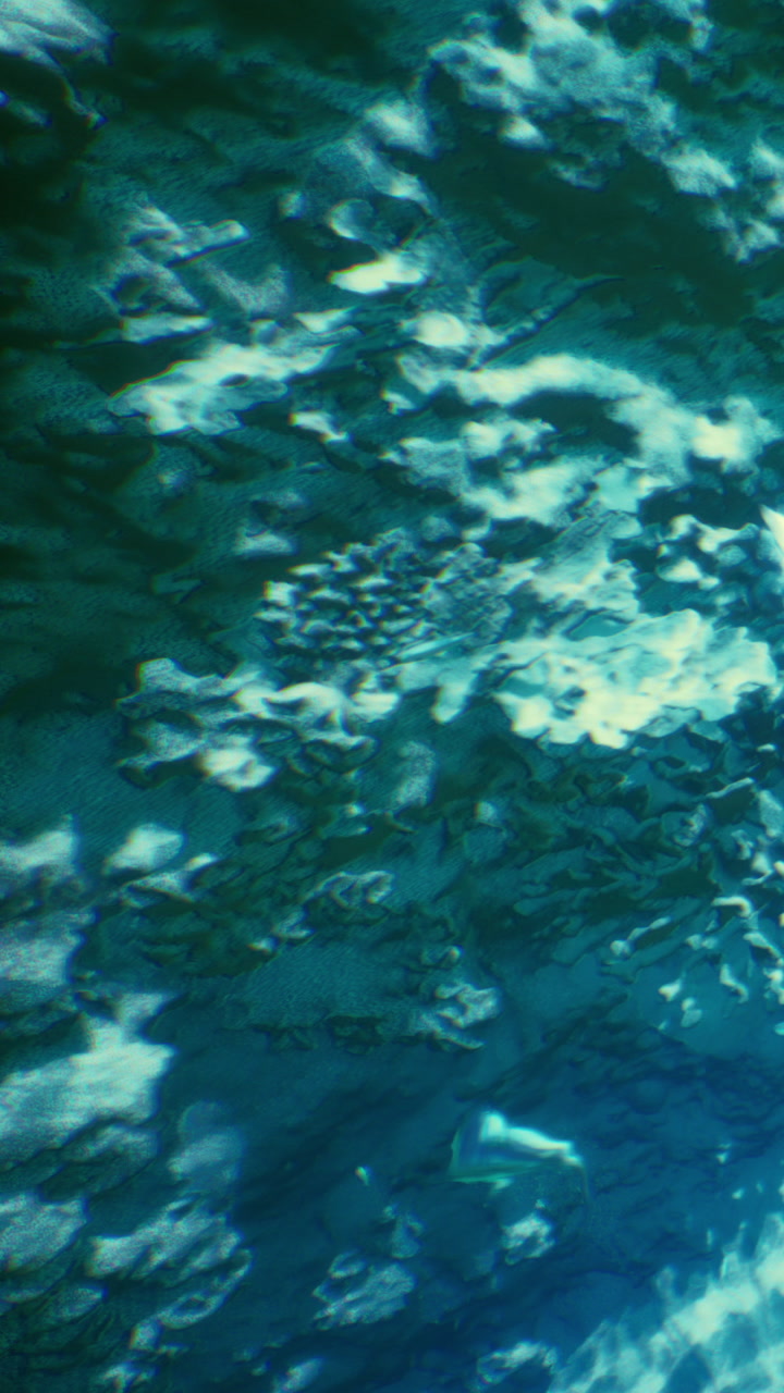 Shimmering ripples dance upon a tranquil blue water surface