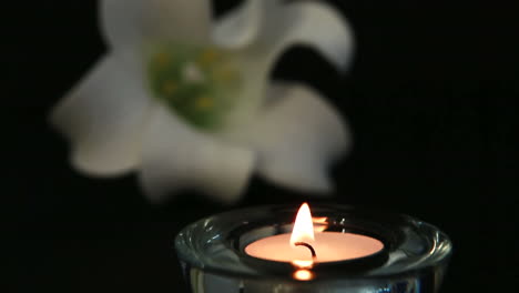 hand lighting candle to remember loss