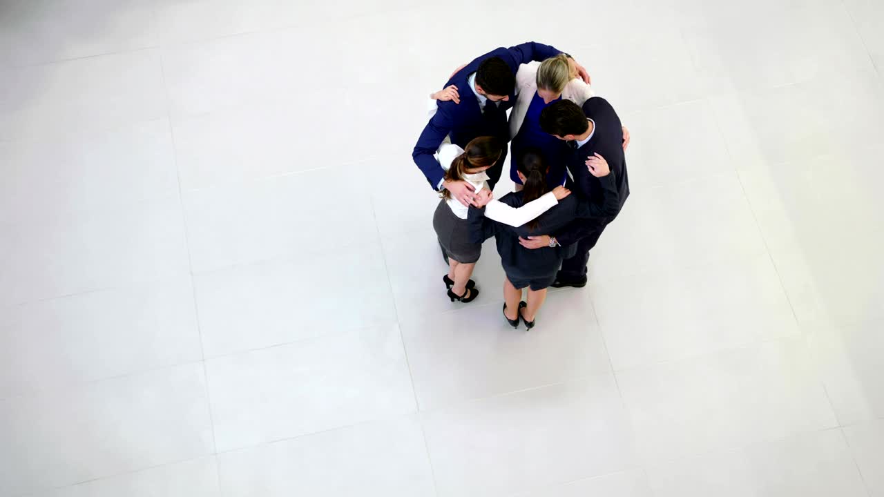 Team of businesspeople forming huddle | Premium Stock Video Footage