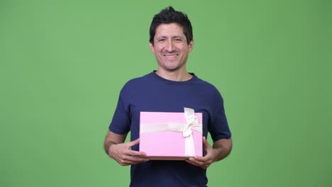 happy hispanic man with gift box