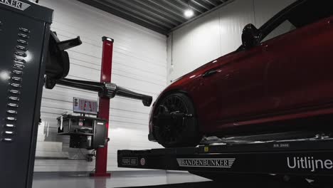 red car being 3d scanned for inspection at a clean mechanic garage