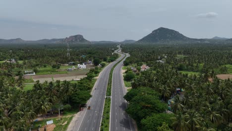 Aerial-view-of-the-highway-running-adjacent-to-industrial-areas-with-factories-and-warehouses