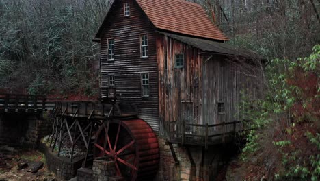 glade creek grist mill in west virginia with bridge and drone video moving up close