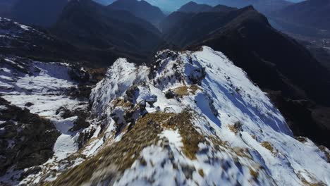 Flying-over-summit-mountain-ridge-over-Resegone-Italian-Alps-with-snow-in-northern-Italy