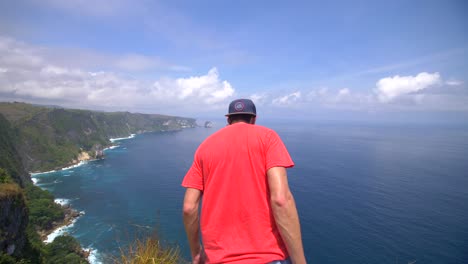 man overlooking indonesian coast