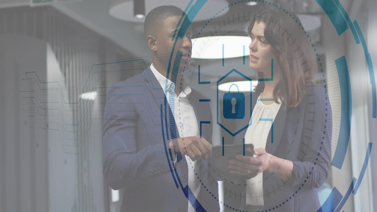 Business professionals discussing security in modern corridor, showing AR padlock overlay on tablet