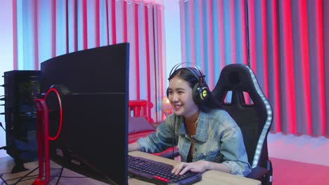 excited girl gamer playing video game on computer