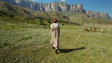 Woman Walking in a Mountain Valley