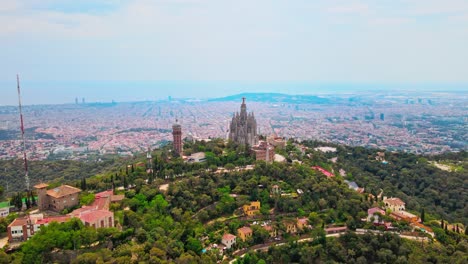 Aerial-drone-4K-footage-of-Tibidabo-in-Barcelona,-showcasing-the-majestic-mountain,-iconic-amusement-park,-and-panoramic-views