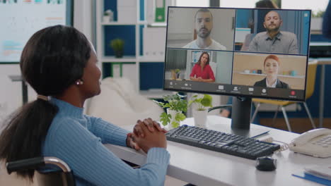 Handicapped-african-manager-woman-discussing-with-remote-colleagues