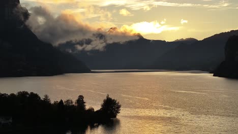 switzerland's walensee lake wrapped in misty clouds, creating a serene and tranquil atmosphere. a peaceful scene that captures nature's gentle beauty in soft, muted tones.