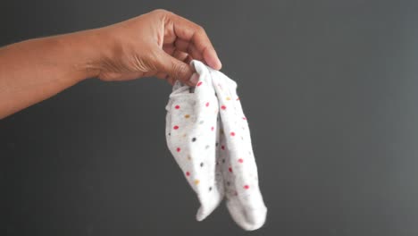 person holding a speckled grey sock