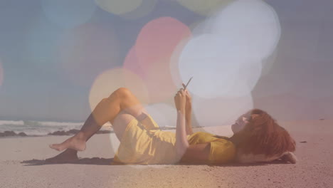 relaxing on beach and using smartphone, person with bokeh lights animation