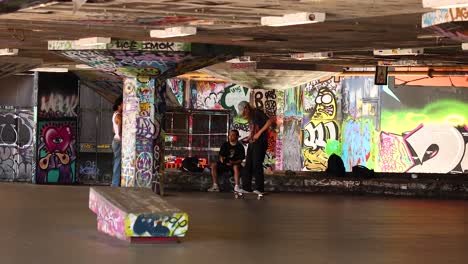 skateboarders performing tricks in urban graffiti setting