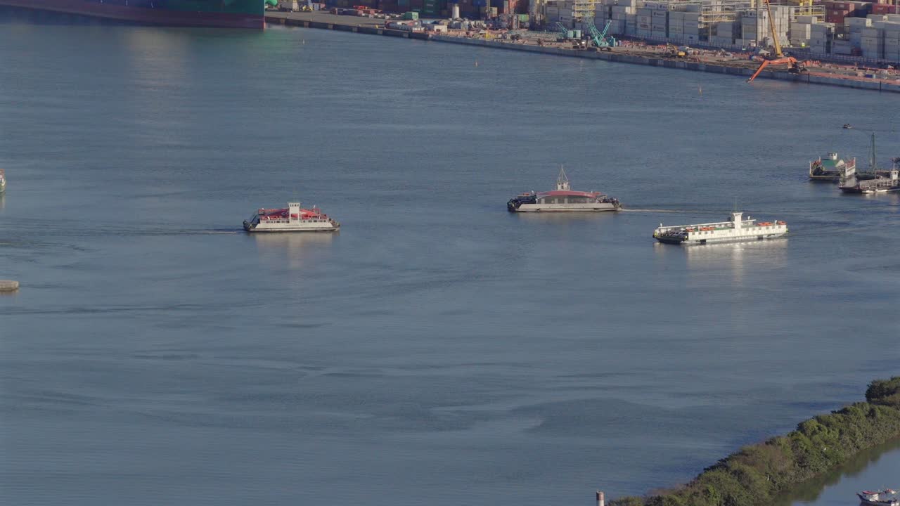 Drone shot following transport ferries moving through ocean waters in Santa Catarina state, Brazil