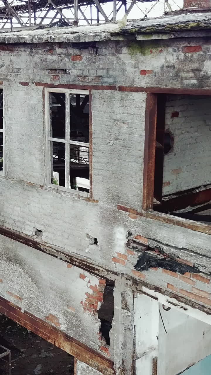 Abandoned factory. Old industrial building for demolition. Aerial view. Vertical video