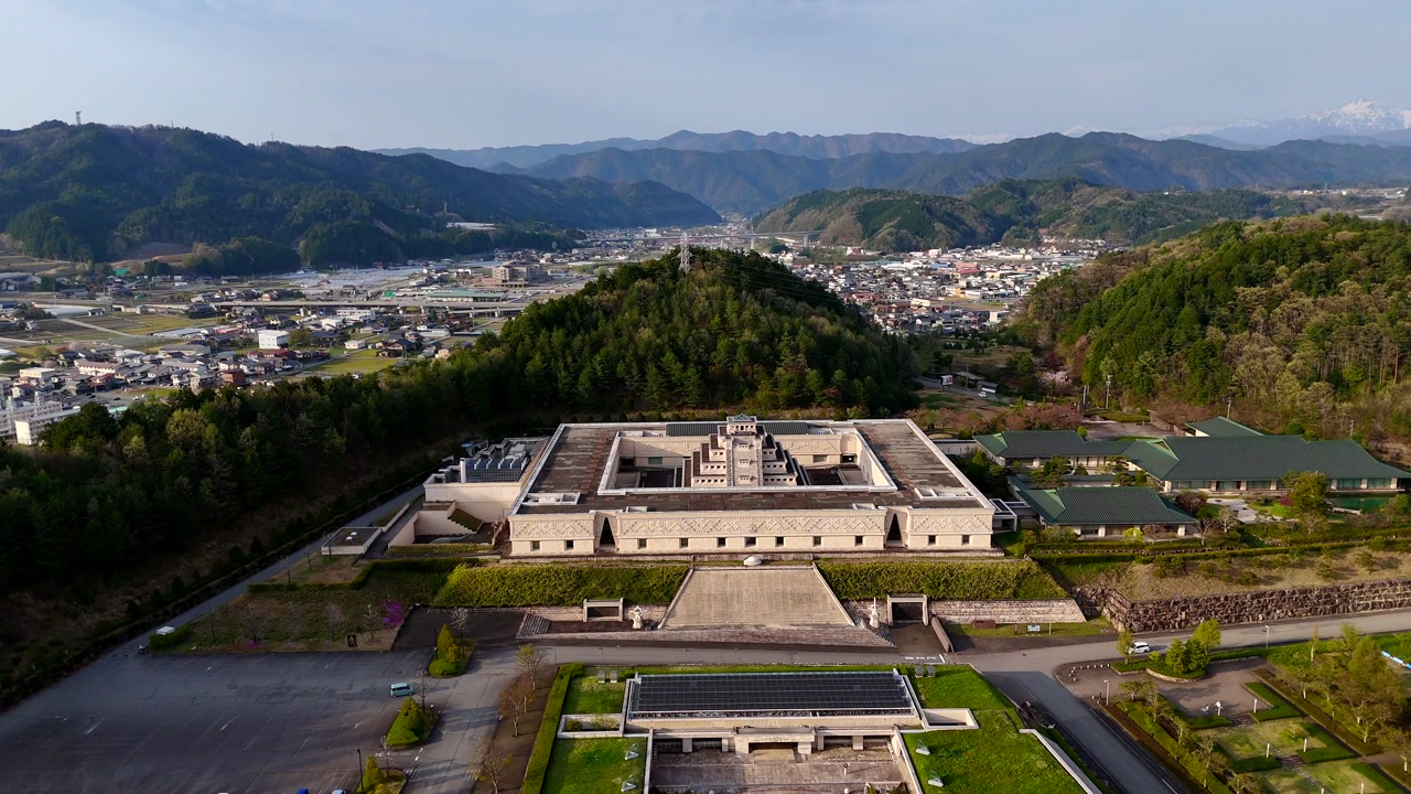Takayama, Japan, Drone shot of Sukyo Mahikari museum pull back shot, with mountains