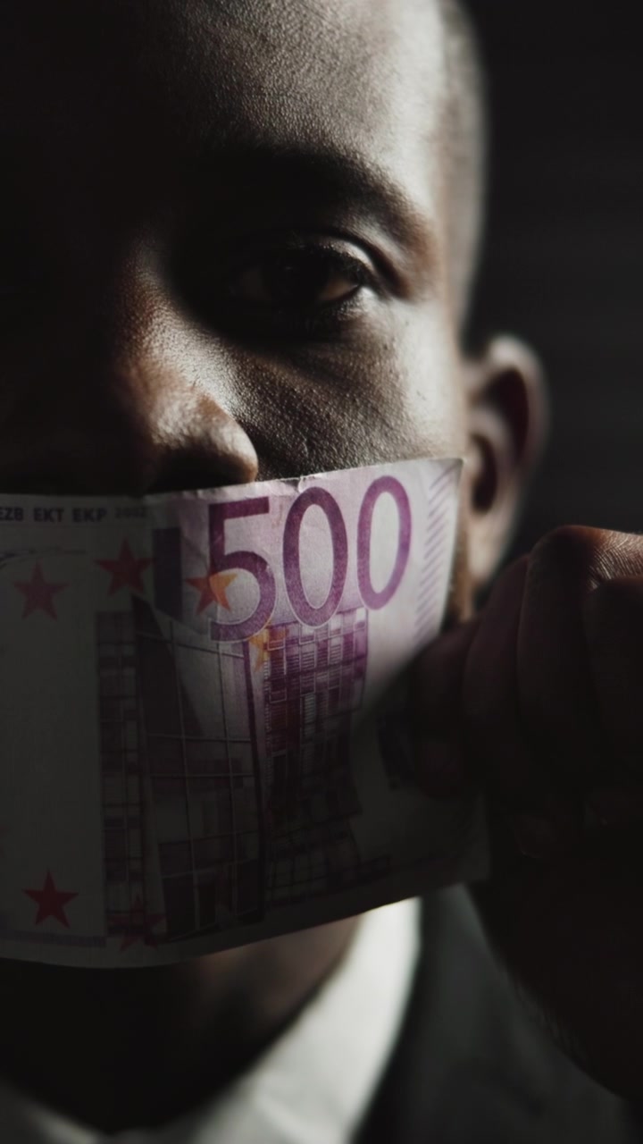 Man Covering Mouth With Five Hundred Euro Banknote