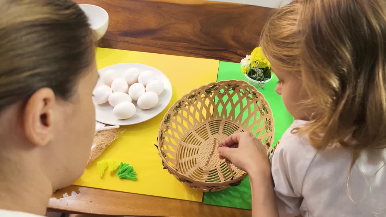 Mother and child decorating Easter eggs together