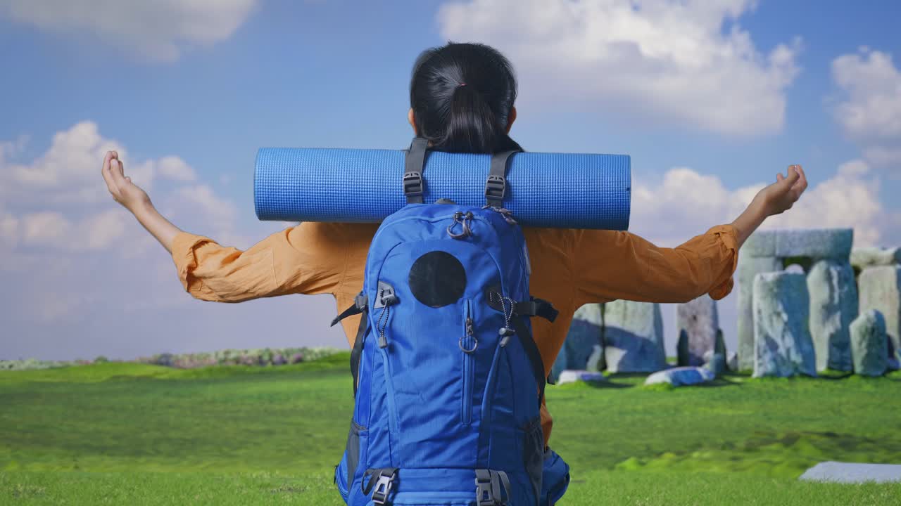 Woman Traveler with Backpack in Front of Ancient Stones