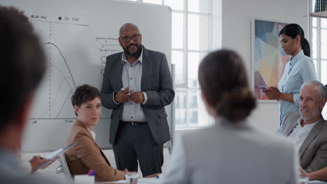 african american businessman presenting project development seminar showing diverse corporate management group ideas on whiteboard in startup office training presentation