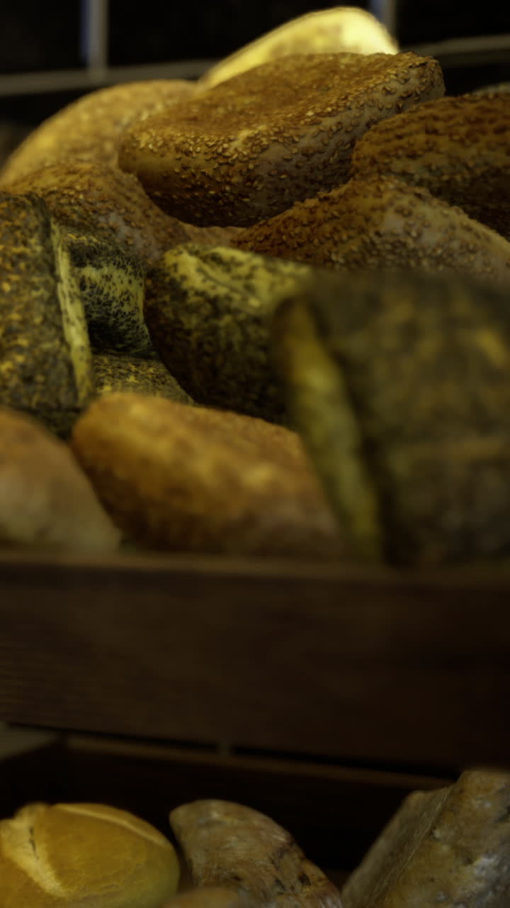 Fresh bread displayed on wooden shelves in a bakery early in the morning