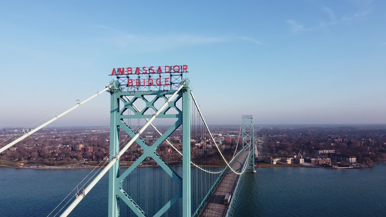 Aerial View Of Ambassador Bridge in Detroit, Michigan extending across Windsor, Canada With Building  - Aerial Shot