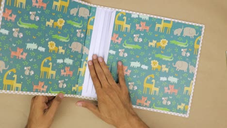 create a baby scrapbook, with colorful animal backgrounds