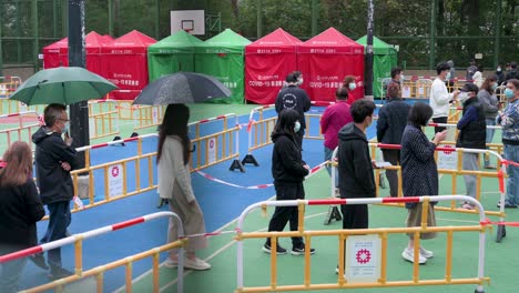 residents wait in line to go through a covid-19 coronavirus testing as a public housing complex is placed under lockdown after a large number of residents tested positive