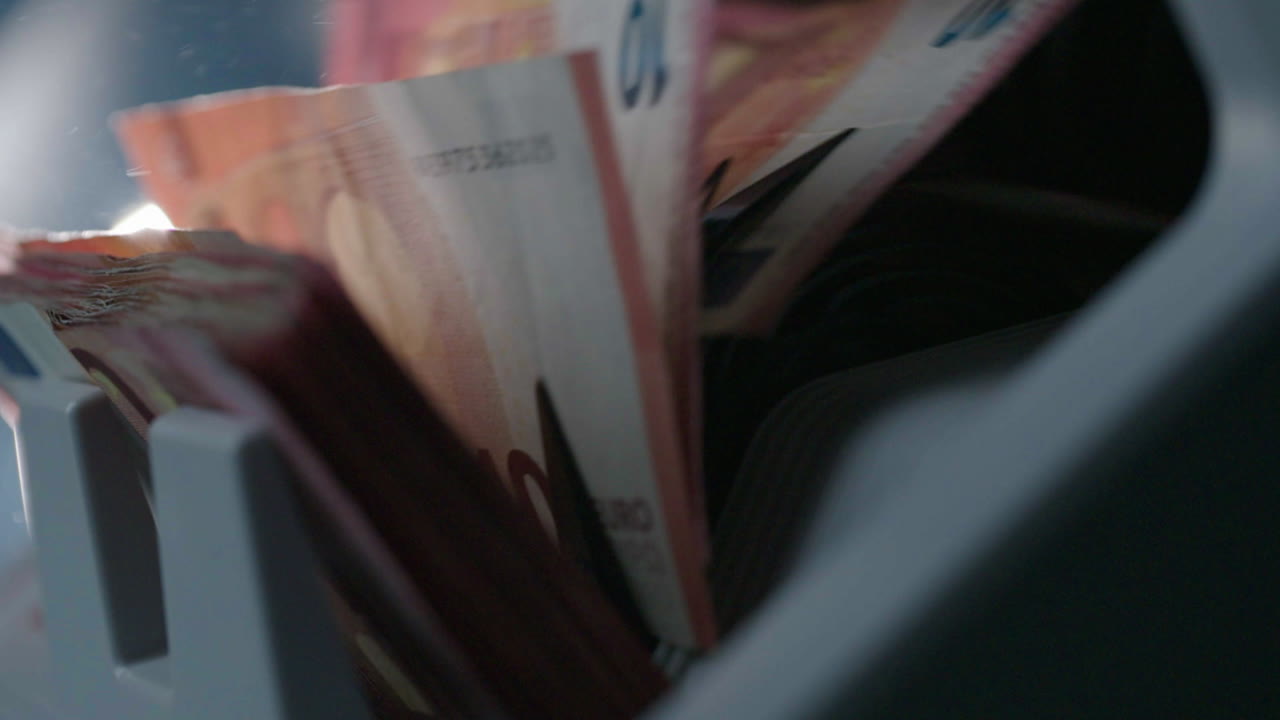 Euro banknotes in a cash dispenser