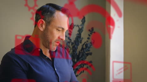 animación de una red de iconos digitales sobre un hombre de negocios usando una tableta
