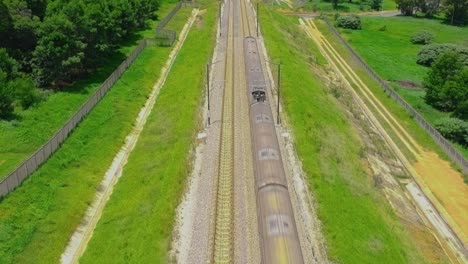 oncoming train pull back drone shot