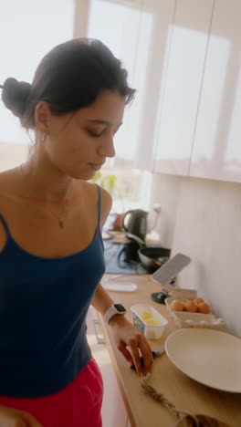 woman preparing breakfast in a kitchen