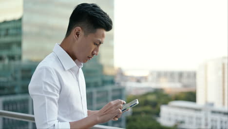 asian man, city business and phone on rooftop