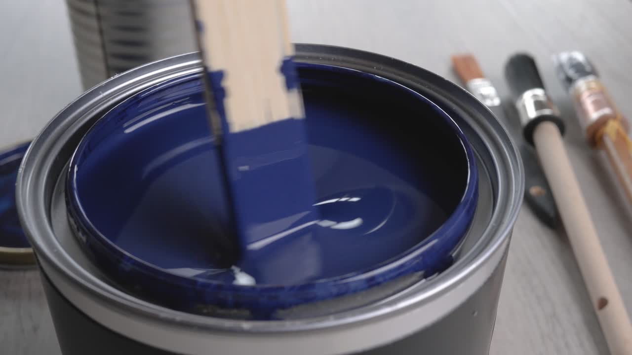 Dipping Paintbrush into Blue Paint Can