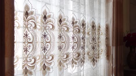 close-up of ornate sheer curtains with embroidered pattern